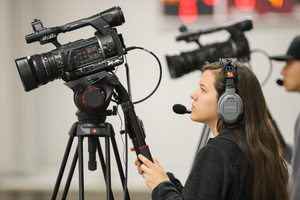 Shayna Johnson and Byron McLaughlin video the basketball game
