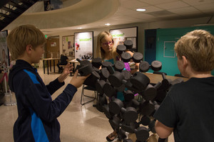 Two children observe the Nano exhibit at CSC