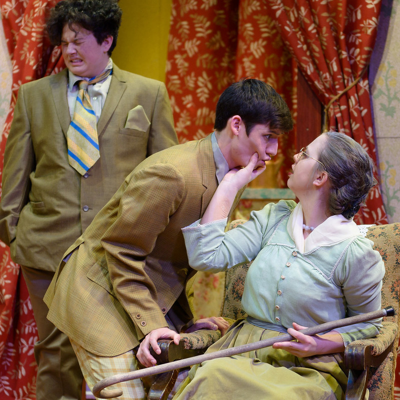 Grandma Kurnitz (Taylor Thies) speaks to her grandson Jay (Wacey Gallegos) as his brother Artie (Brie Royle) winces in sympathy