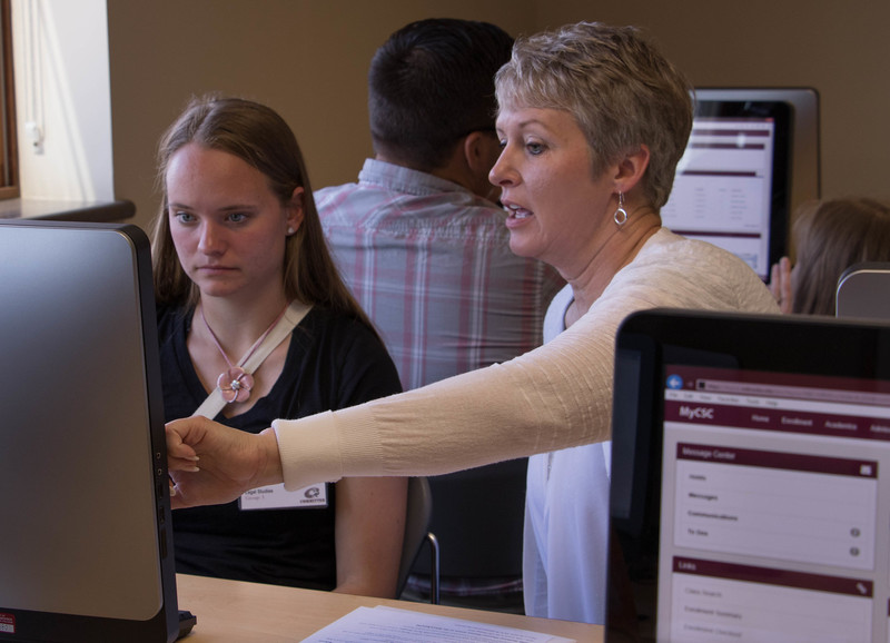 Tindra Norris, left, of Mead, Colorado, works through her fall course schedule with guidance from Dr. Tracy Nobiling during a June 2016 Signing Day.