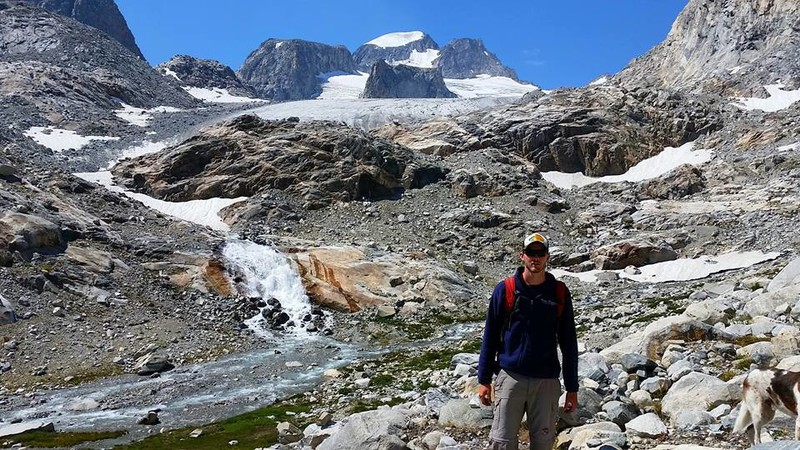 Chadron State College graduate student Adam Neumann poses below the Dinwoody Glacier and Gannett in Wyoming's Wind River Range in June 2016 where he conducted glacial research related to the study of climate change.