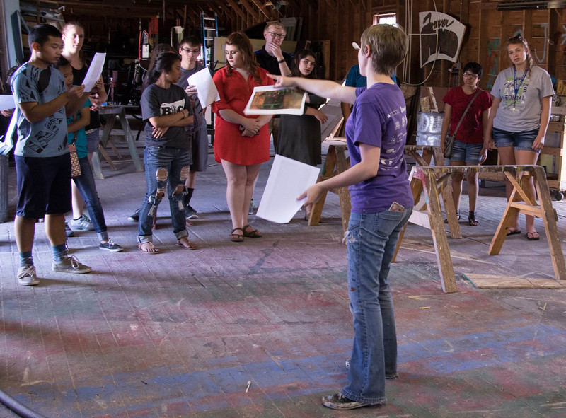 Erin Skelley, center, shares sketches of sets and props during an Upward Bound tour of the Post Playhouse June 21, 2016.