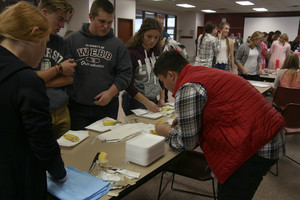 Jonathan Sayaloune demonstrates suturing to high school students