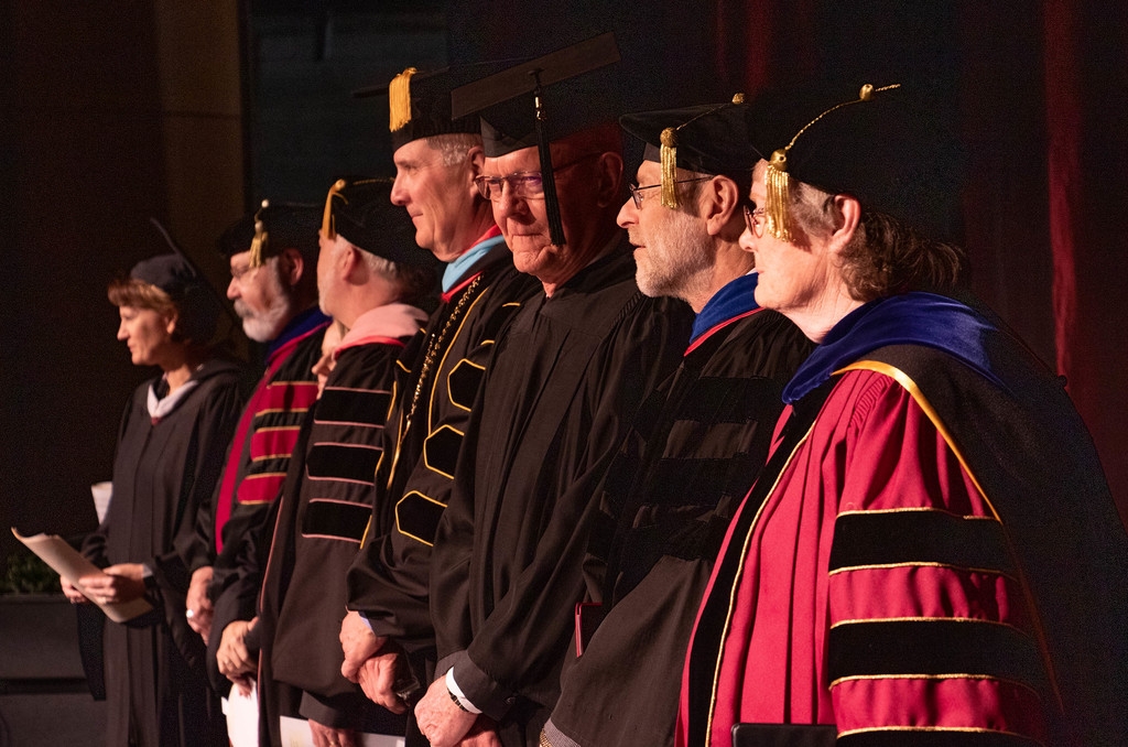 CSC Graduates stand on stage