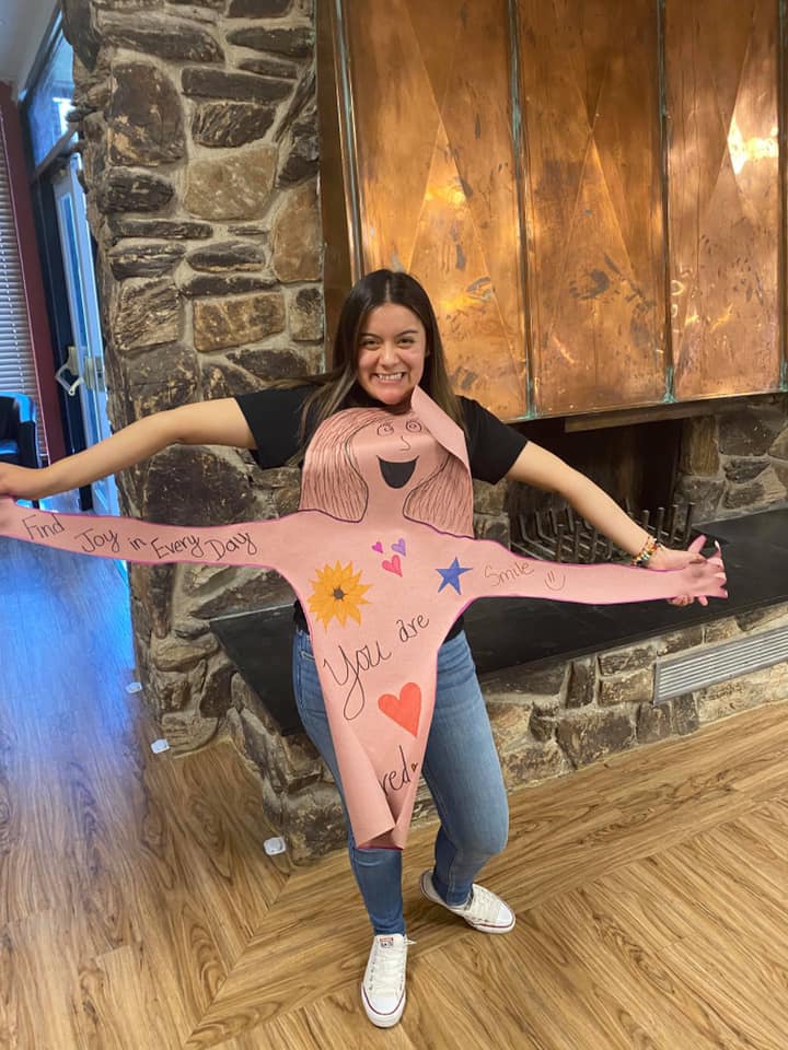 Paola Rodriguez of Marquette poses for a photo with a “hug” she created for Crest View Care Center residents