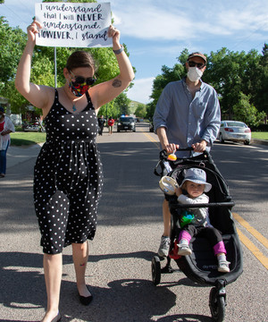 Caitlin Rovner, Jonathan Rovner, and their daughter, Penelope, join in a Black Lives Matter protest