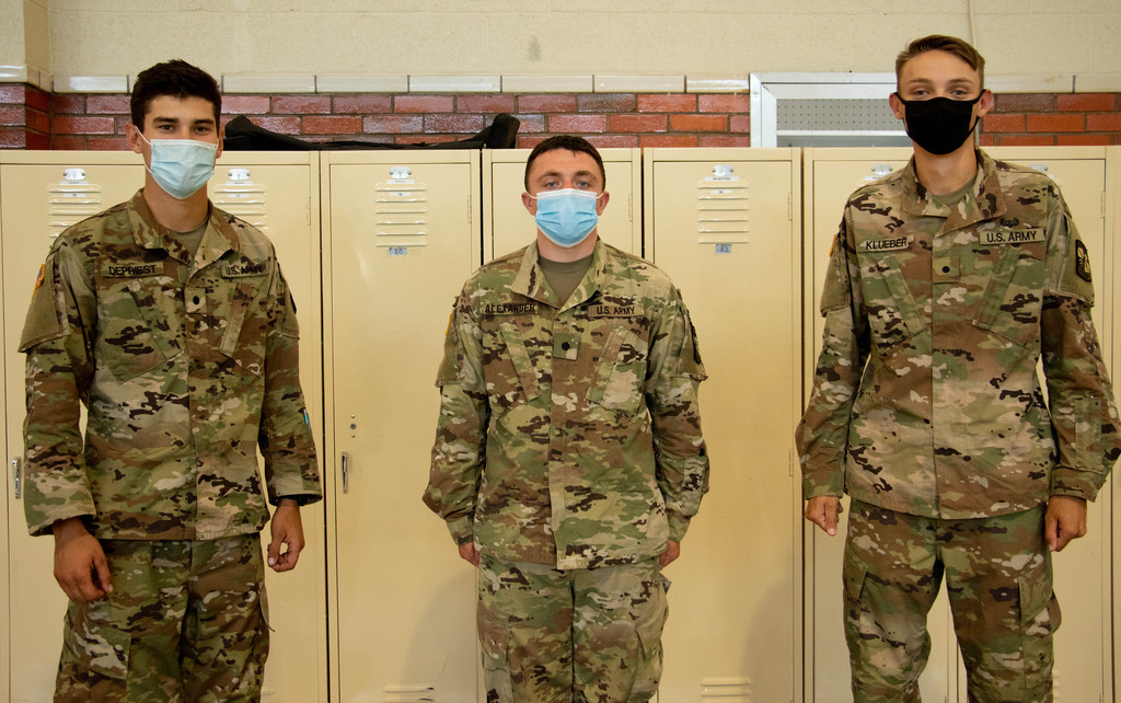 Calvin DePriest, Colton Alexander and Konery Klueber pose at the National Guard Armory near CSC.