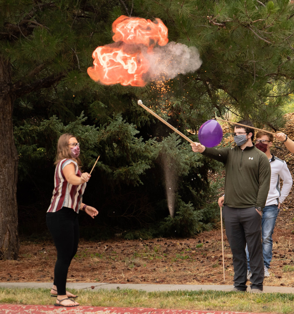 Kelli Schoch lights a ceremonial hydrogen balloon.