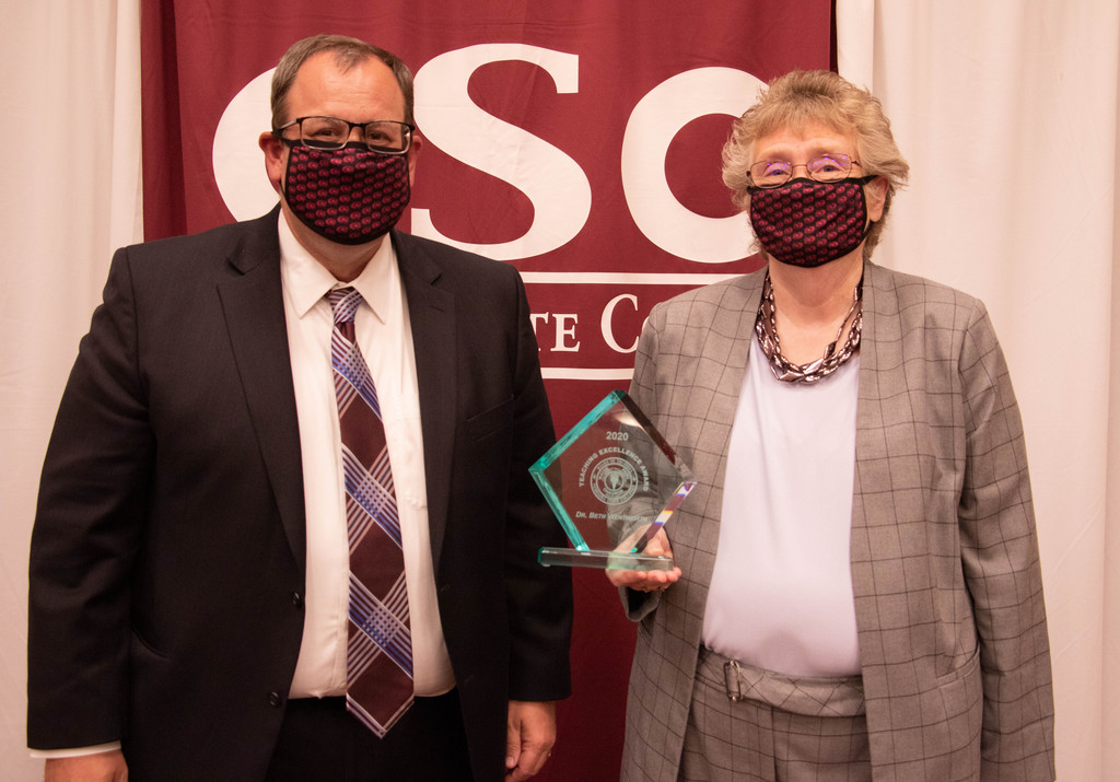 Matthew Bloomstedt poses with retired professor Dr. Beth Wentworth at a Nebraska State College System dinner