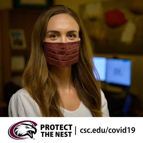 A student poses in a mask for Protect the Nest during the COVID-19 pandemic.