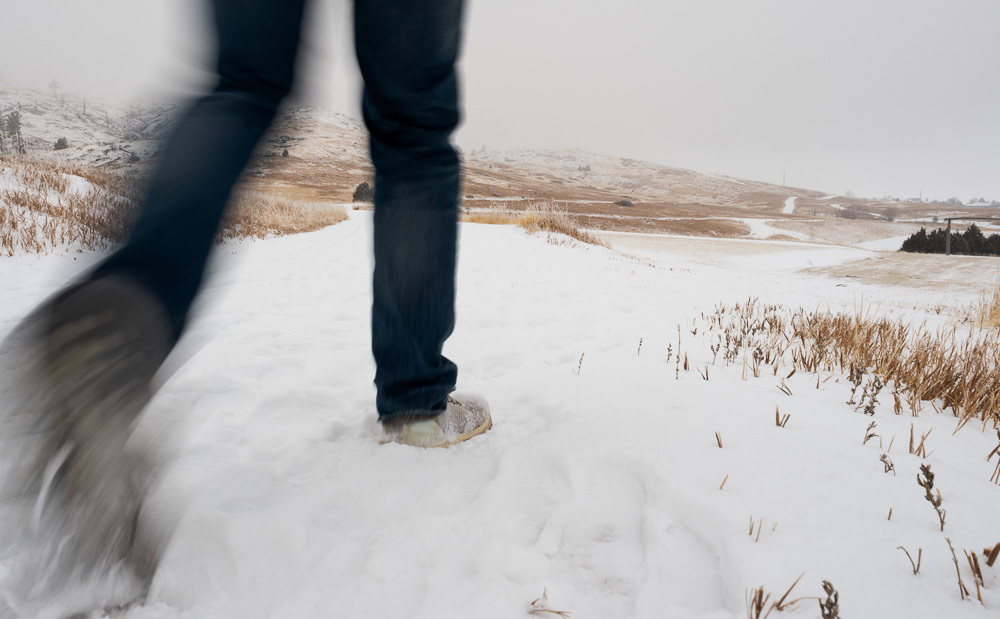 John Murphy, digital graphic designer, walks along the trail on the south end of campus near the Chadron water tower