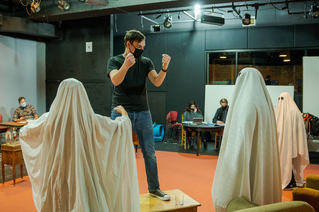 Zak Wellnitz, on table, rehearses a scene from
