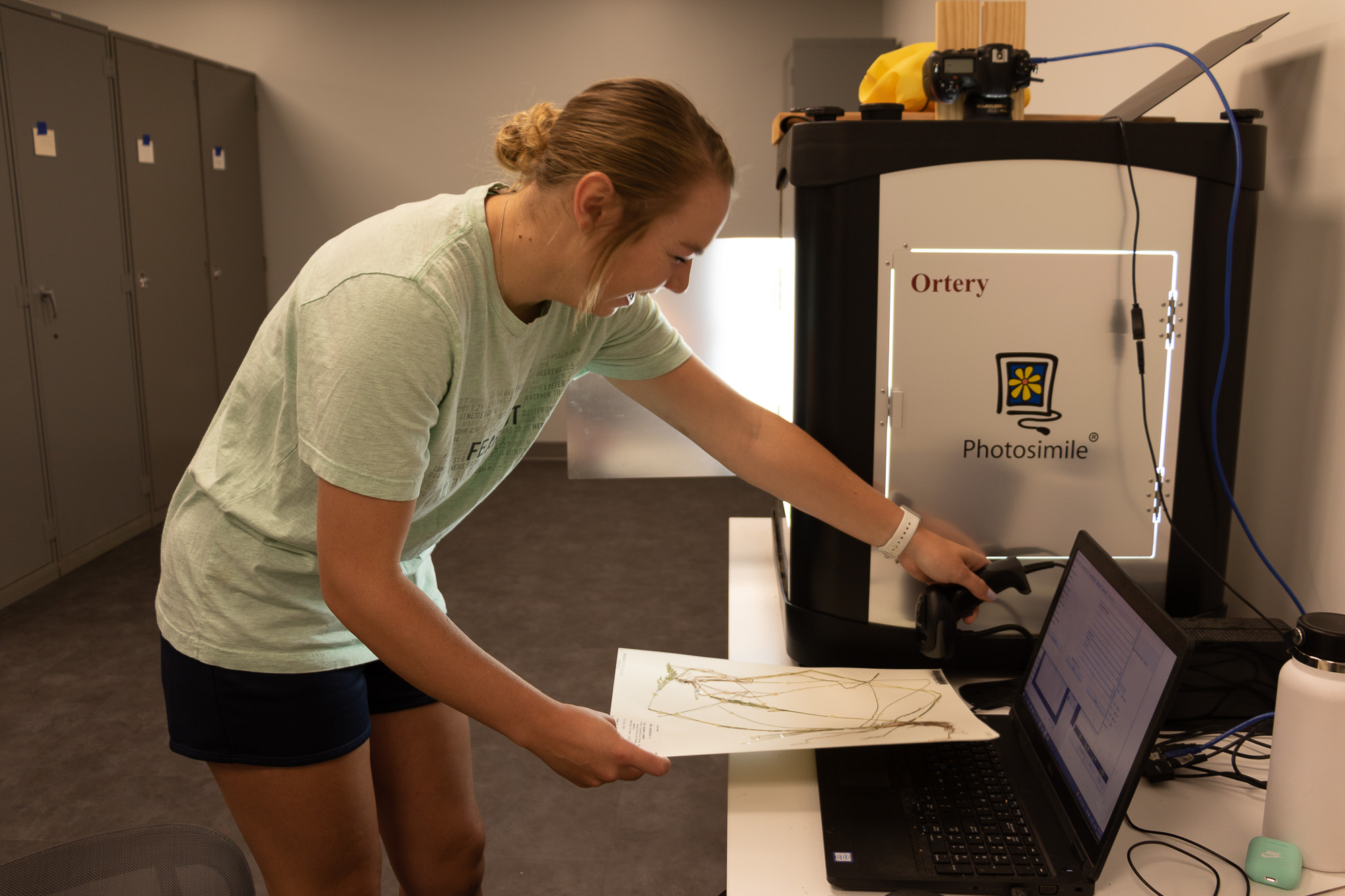 student scanning a plant specimen
