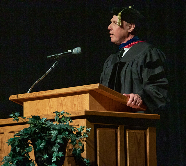 Man speaking at a podium