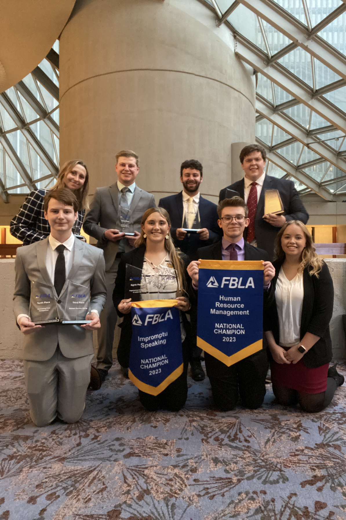 Students posing with awards