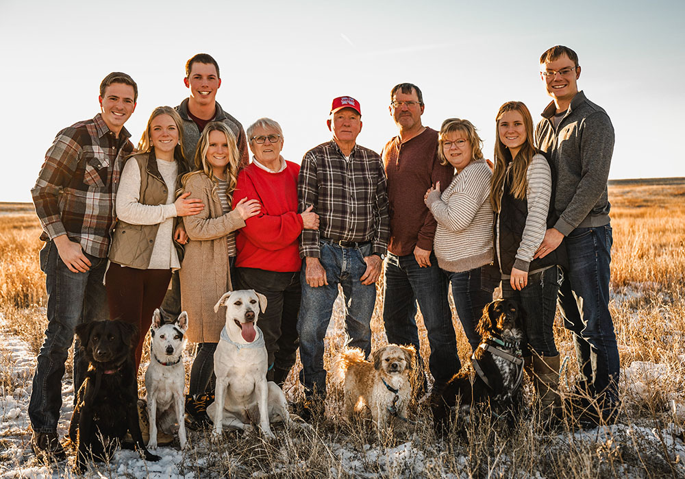 Group of adults standing outside with their dogs