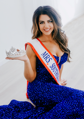 Woman in a gown posing with a crown
