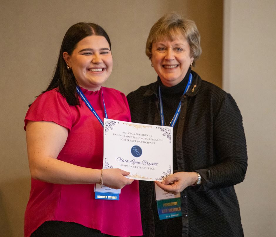 Two women standing with an award