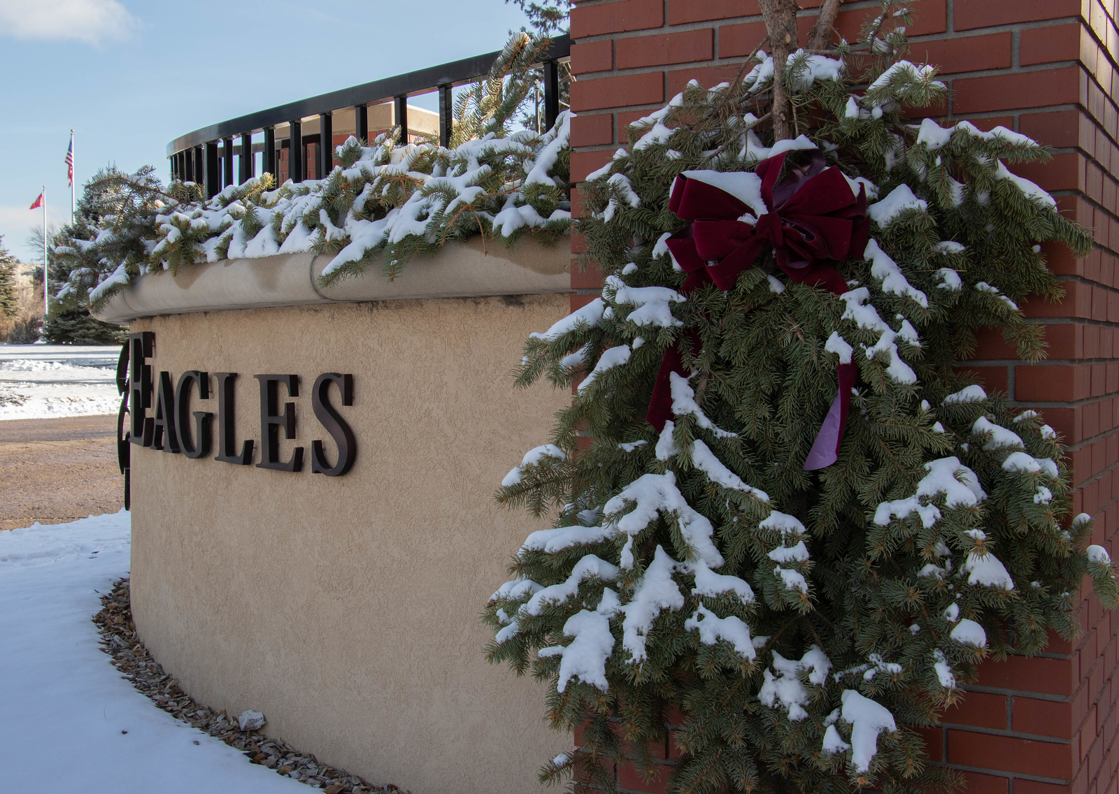 Snow on campus entrance sign