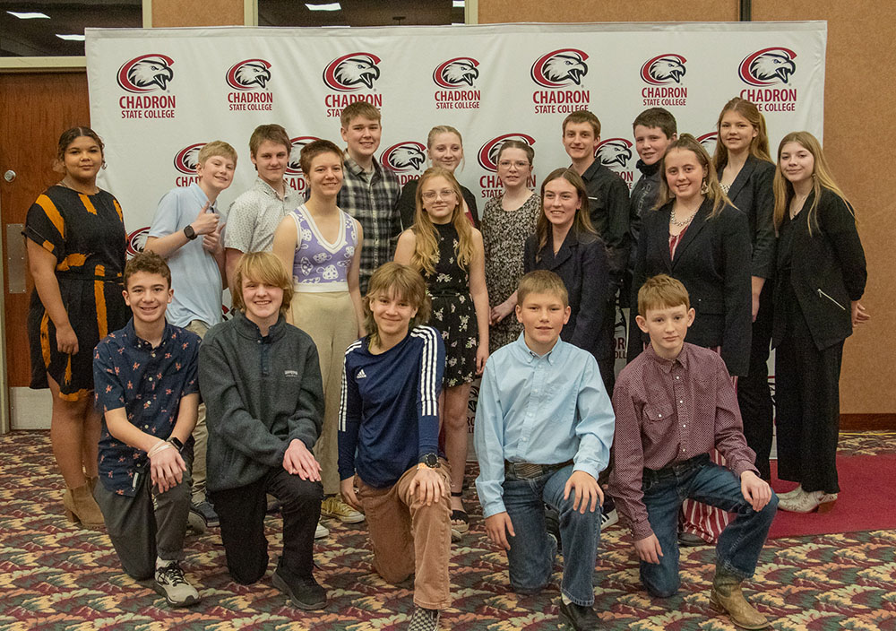 Group of students posing in front of backdrop