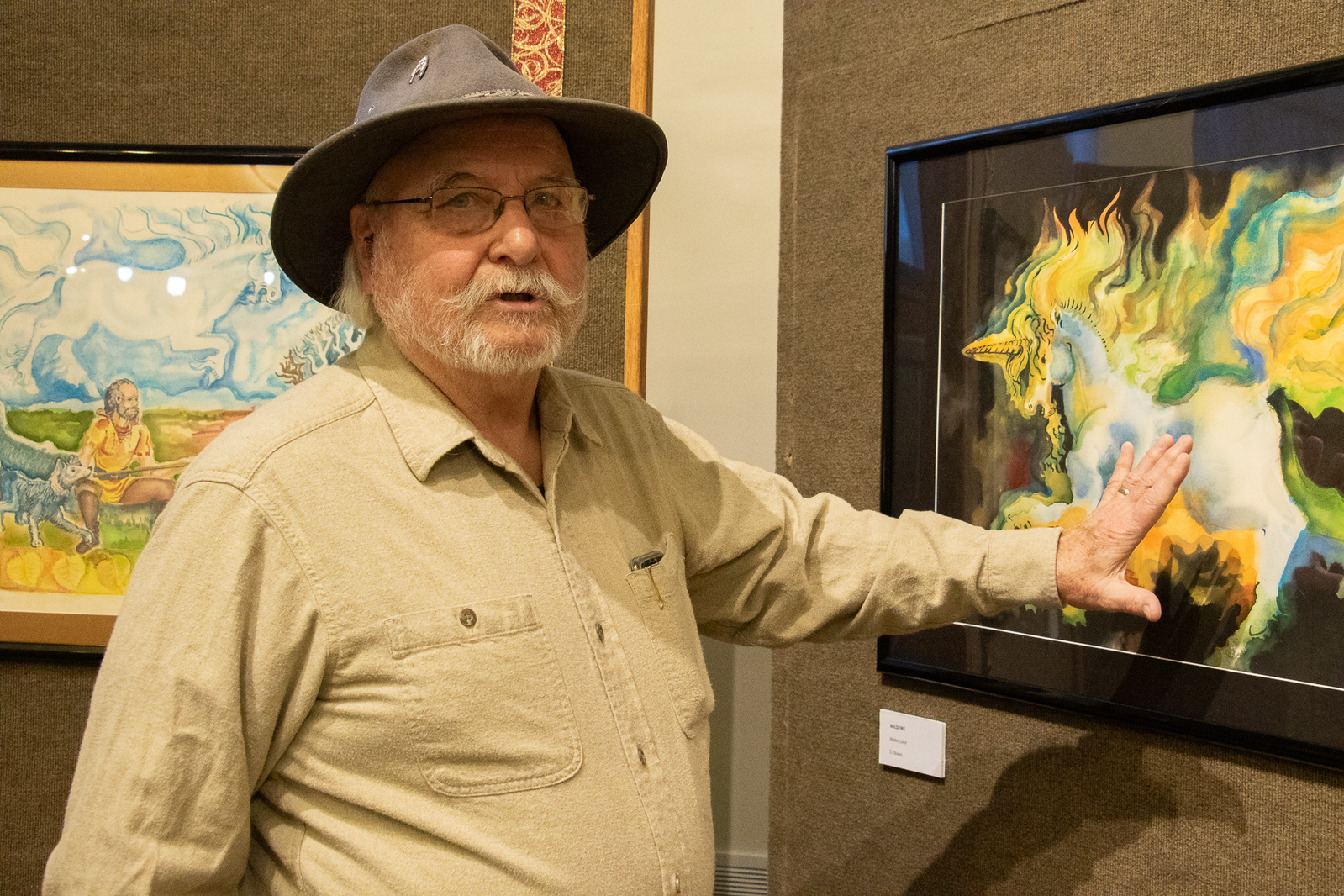 Male artist standing with painting