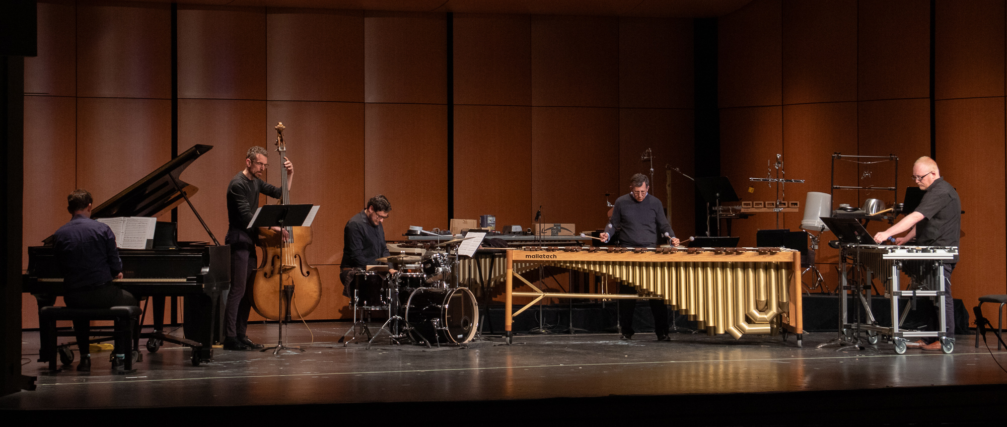 Percussionists and other musicians playing on a stage