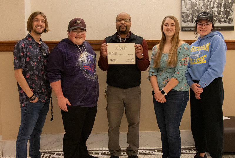 Group of students posing with professor