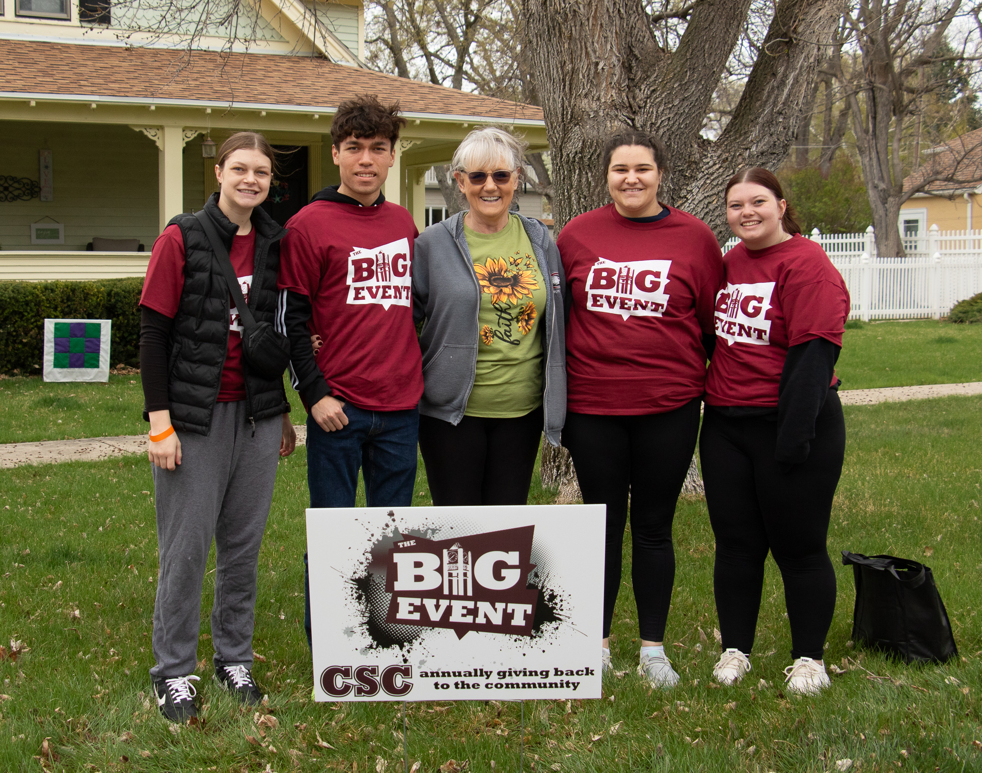 Five adults posing outside