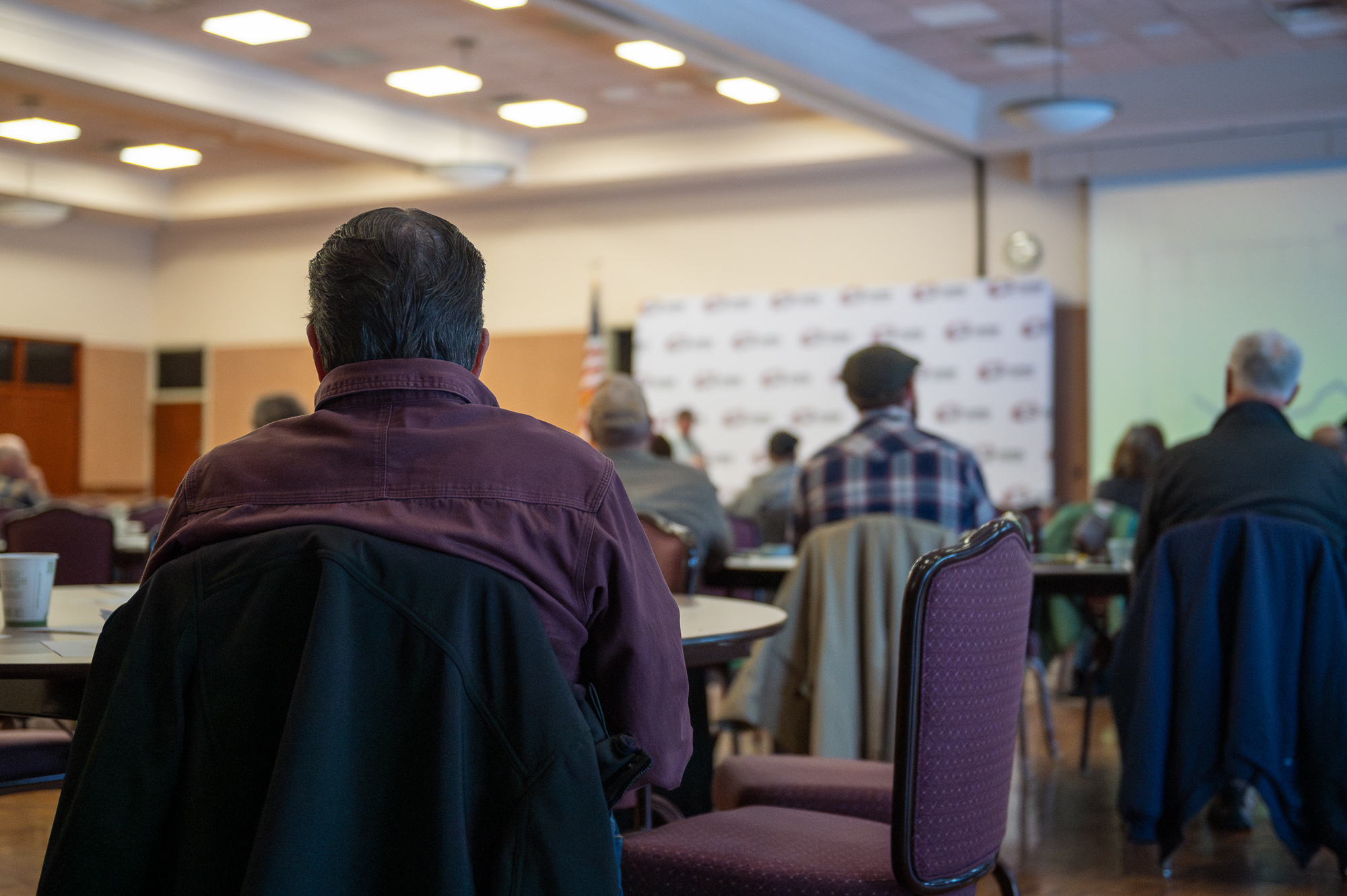 Audience sits in the Student Center Ballroom viewing a lecture.