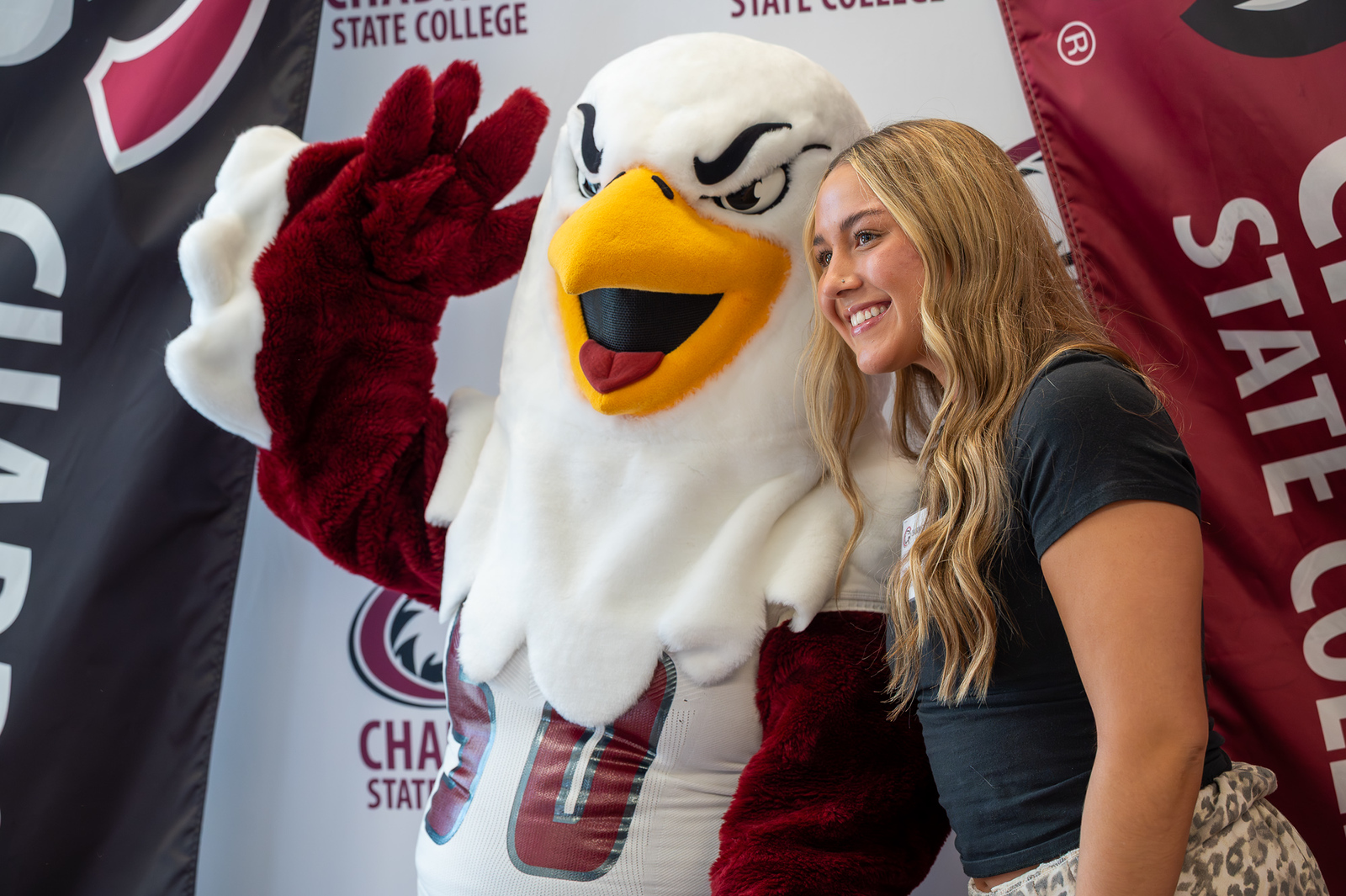 Eagle mascot posing with a student