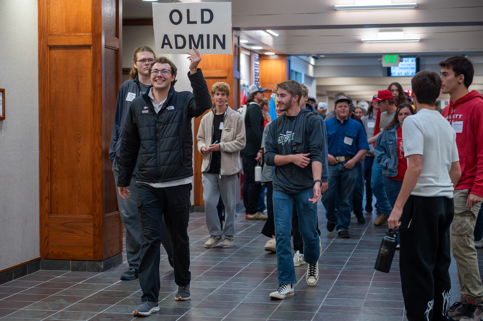 Group of students walking in a campus building