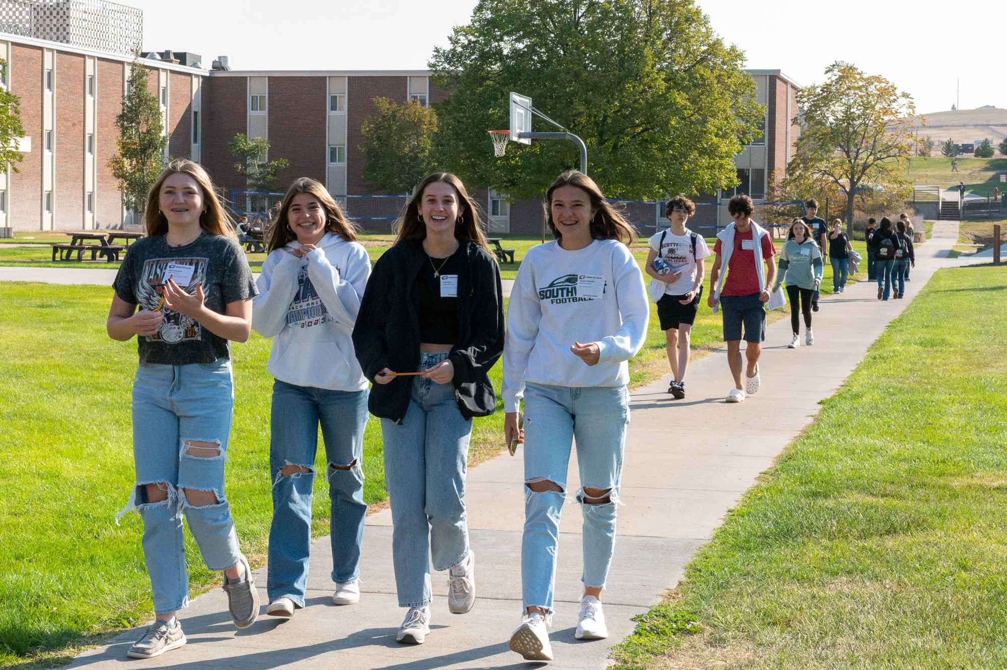 Four students walking on campus