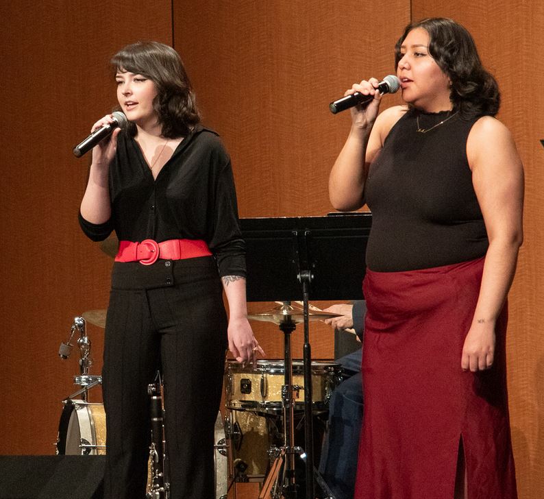 Two women on a stage performing music