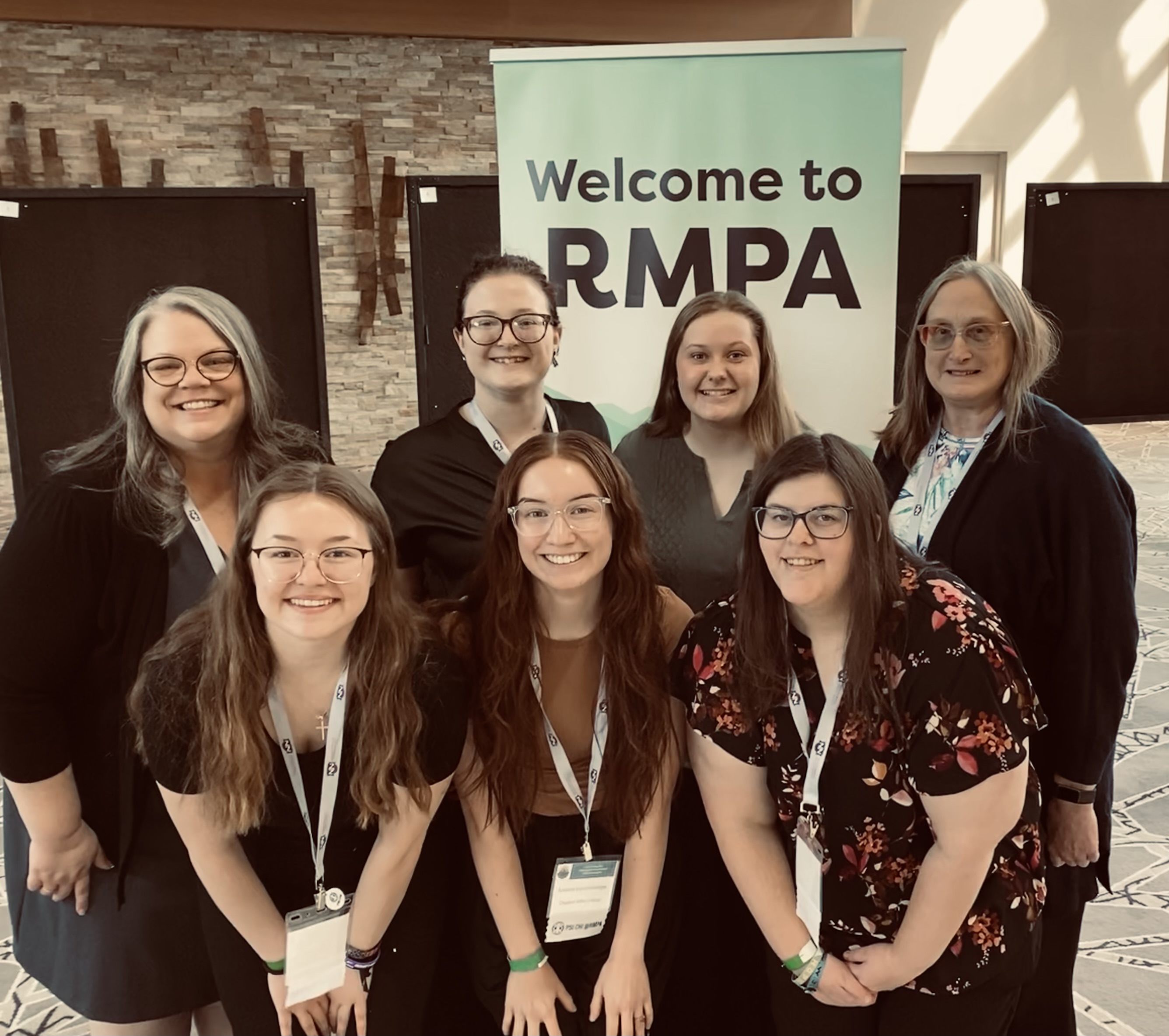 Group of adults posing at a conference