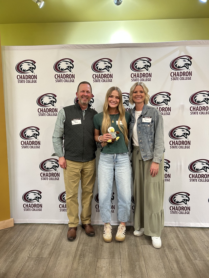 Family posing in front of a backdrop