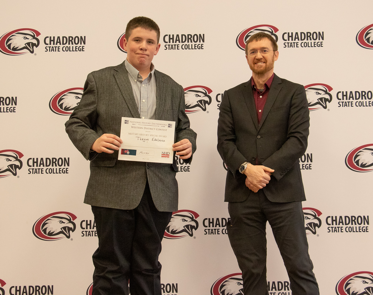 Two men posing with a history award