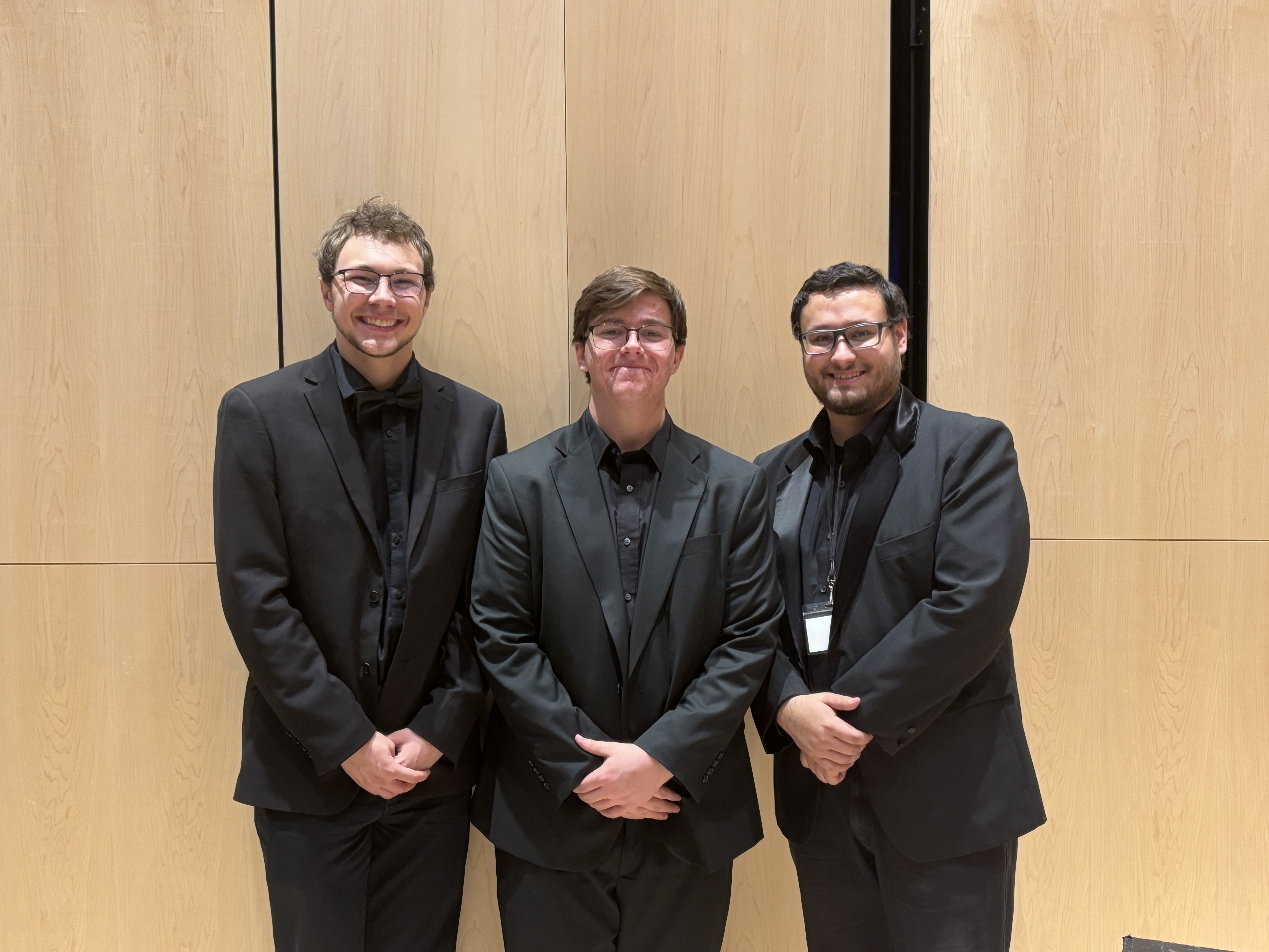 Three music students posing inside