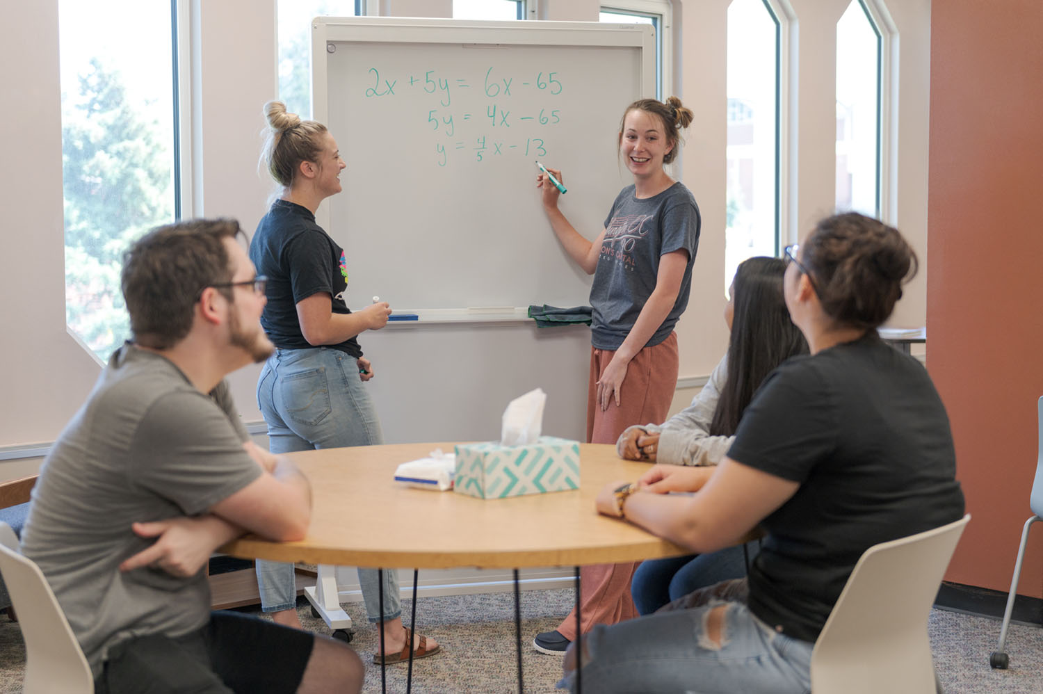Student tutors work on an algebra problem in the Learning Lab