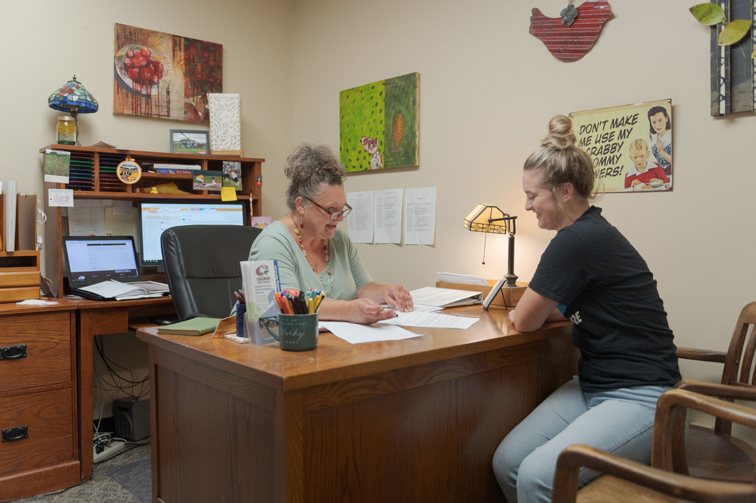 A student and staff member review internship requirements