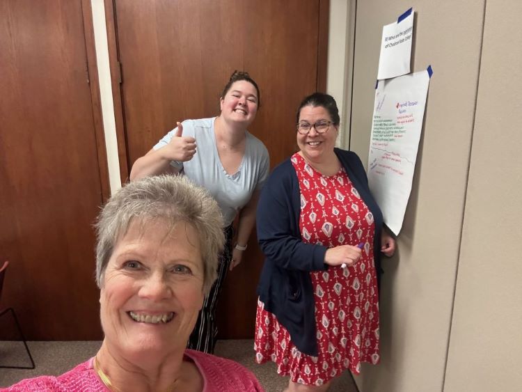 Becca Monahan, Christine Fullerton, and Tena Cook working on the SOAR Analysis at a PSA meeting