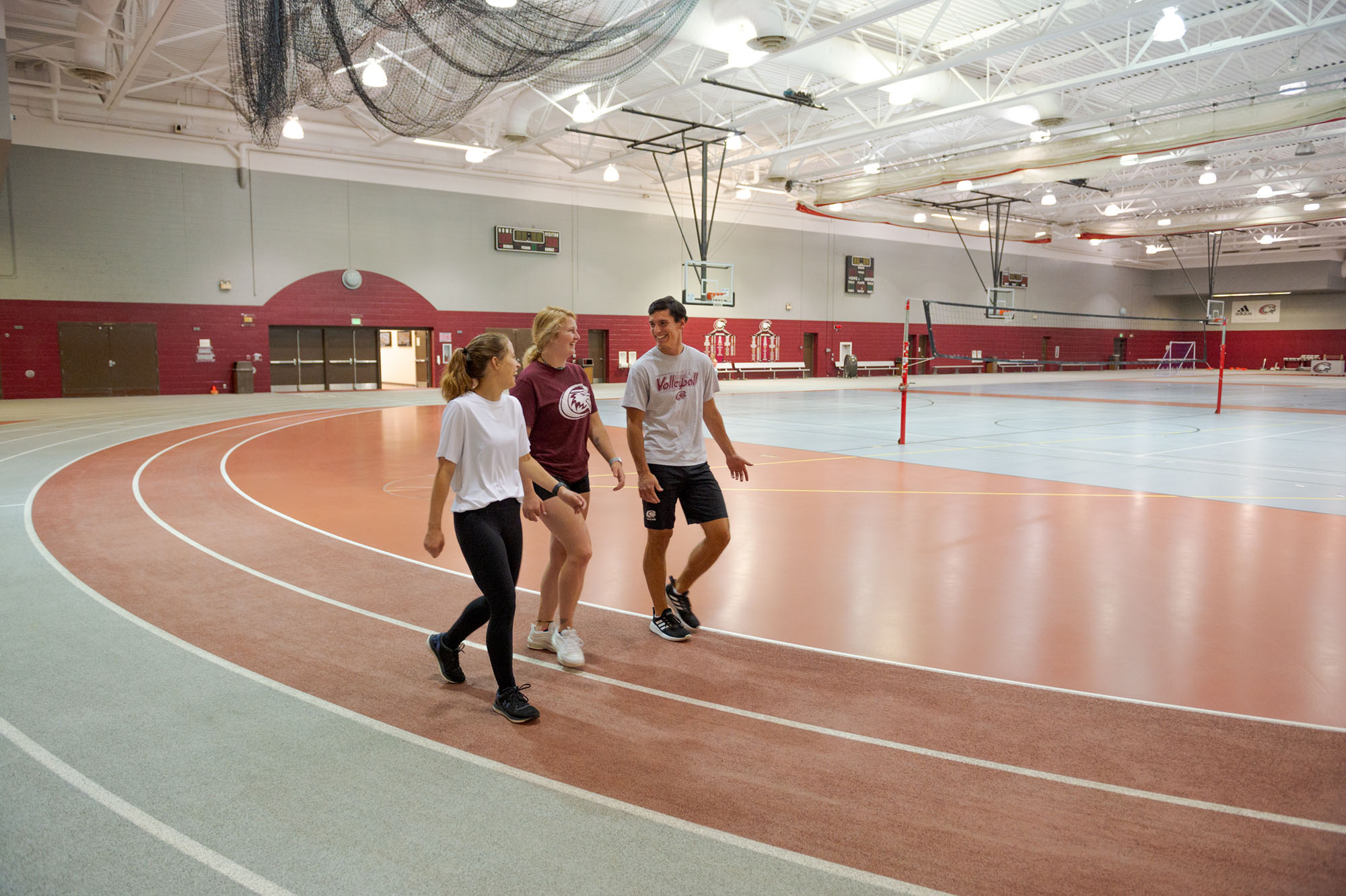 Photo of students walking for exercise around the indoor track at the NPAC