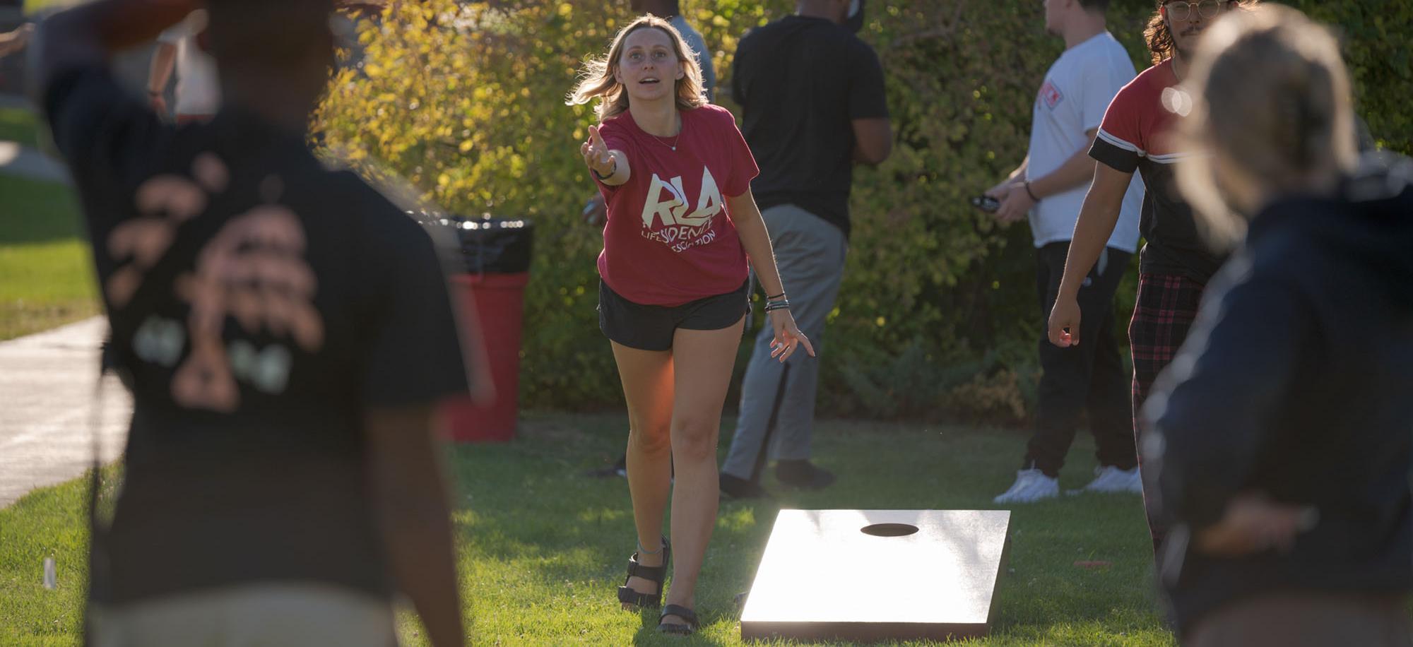 Students playing a bean bag toss