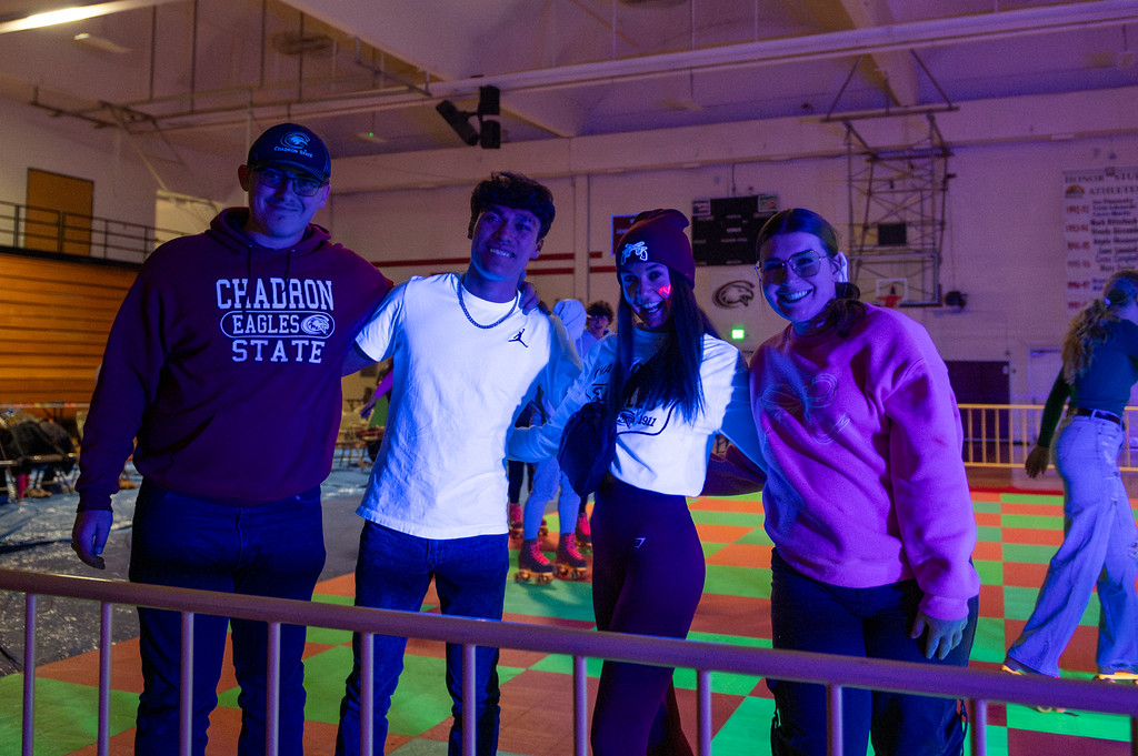 Photo of 4 students at the glow in the dark roller rink
