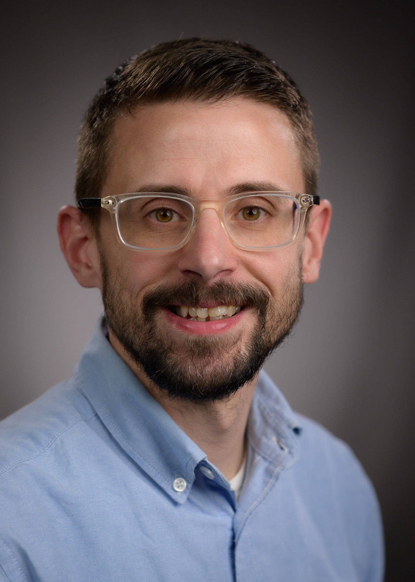 man, glasses, beard, smiling, blue shirt