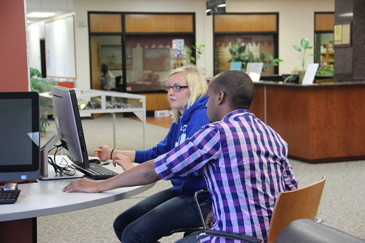 Help Desk staff helping a student in the Library.
