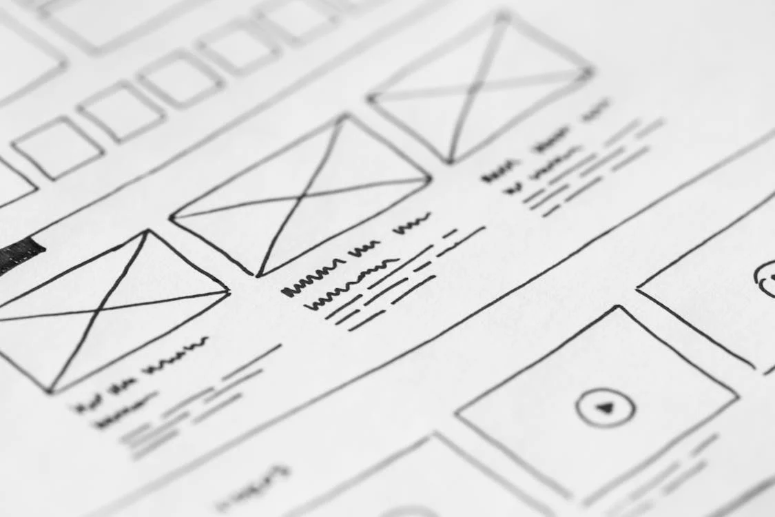 Sketches of boxes and text blocks for design layout.