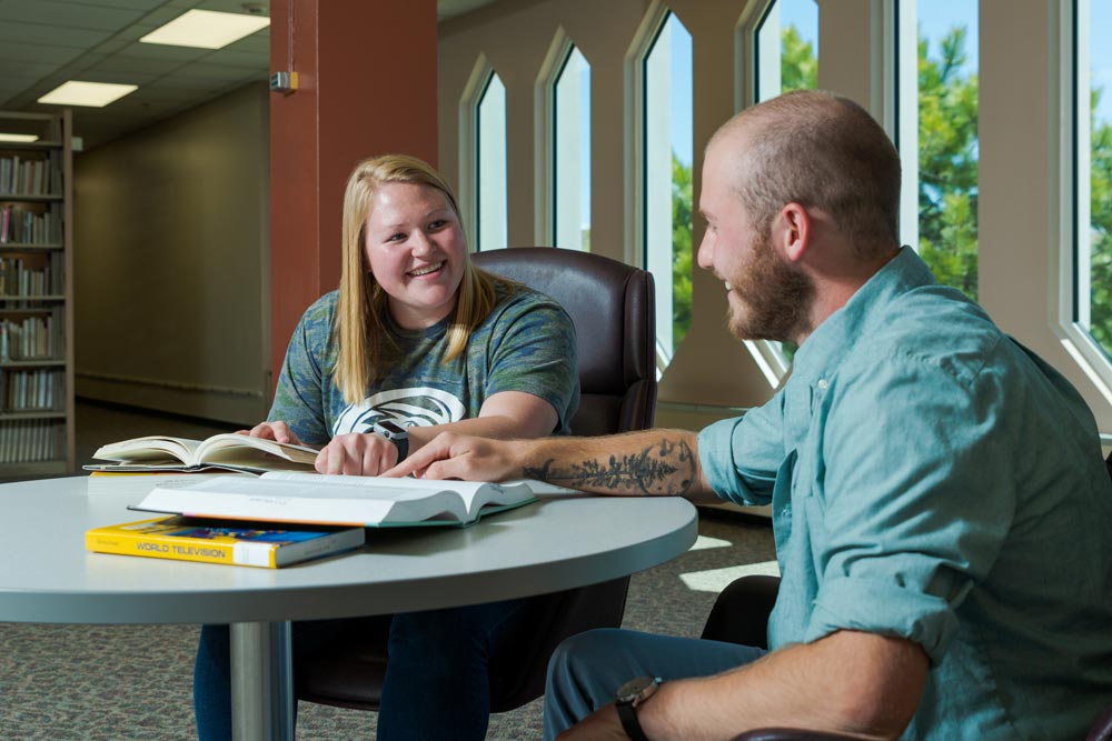 Two students reviewing material in the King Library