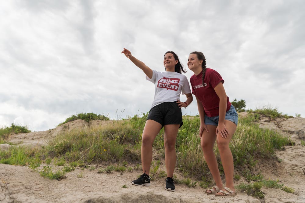Two students hiking on C-Hill